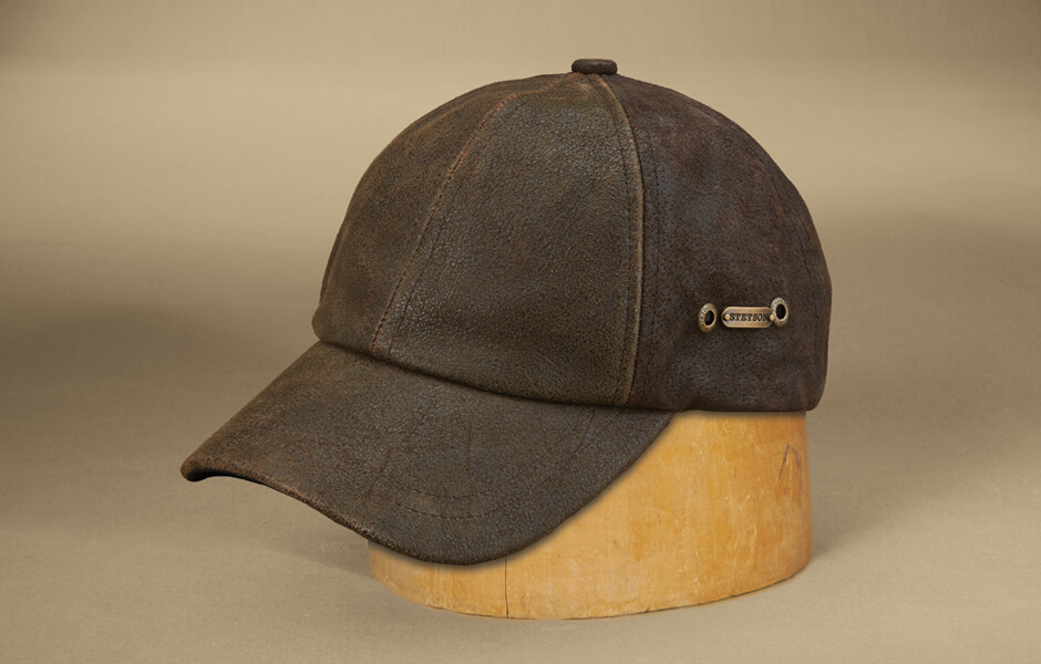 Brown ballcap hat on wood block